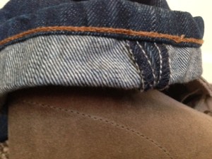 A closer look at cuffed pair of denim atop the classic desert boot. 