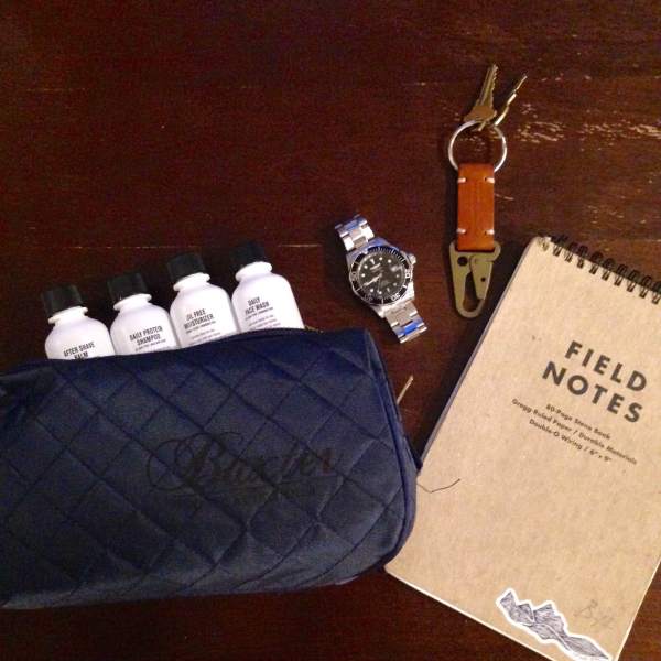 Prepped to travel with key essentials from Baxter. Notebook by Field Notes. Keychain by Apolis.