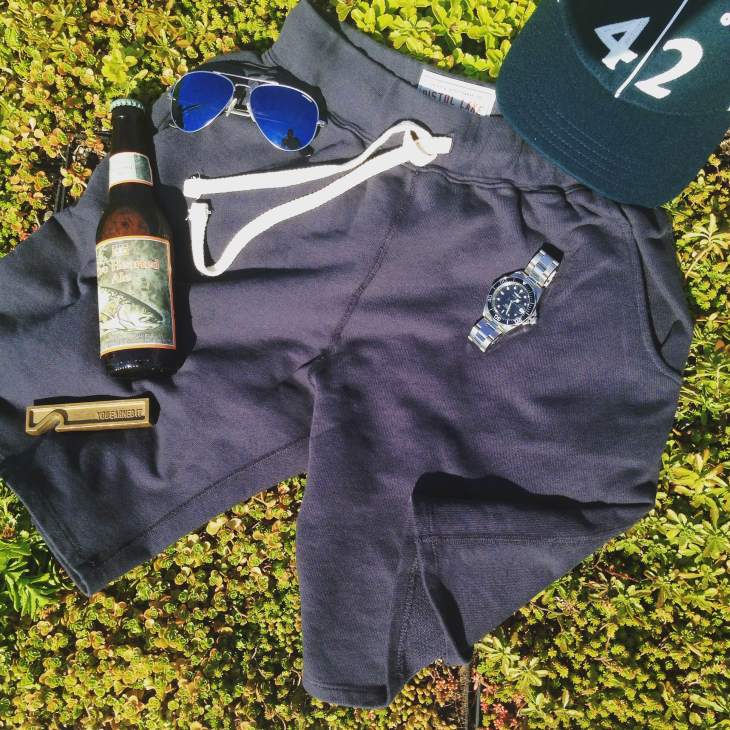 Perhaps the best representation of the kind of gear you should have on-hand for the weekend. French Terry Sweatshorts by Pistol Lake. Stainless steel dive watch by Invicta. Sunglasses by Randolph Engineering. Vintage ballcap by Goorin Brothers. Brass bottle opener by Owen & Fred. Two-Hearted Ale by Bell's Brewing.