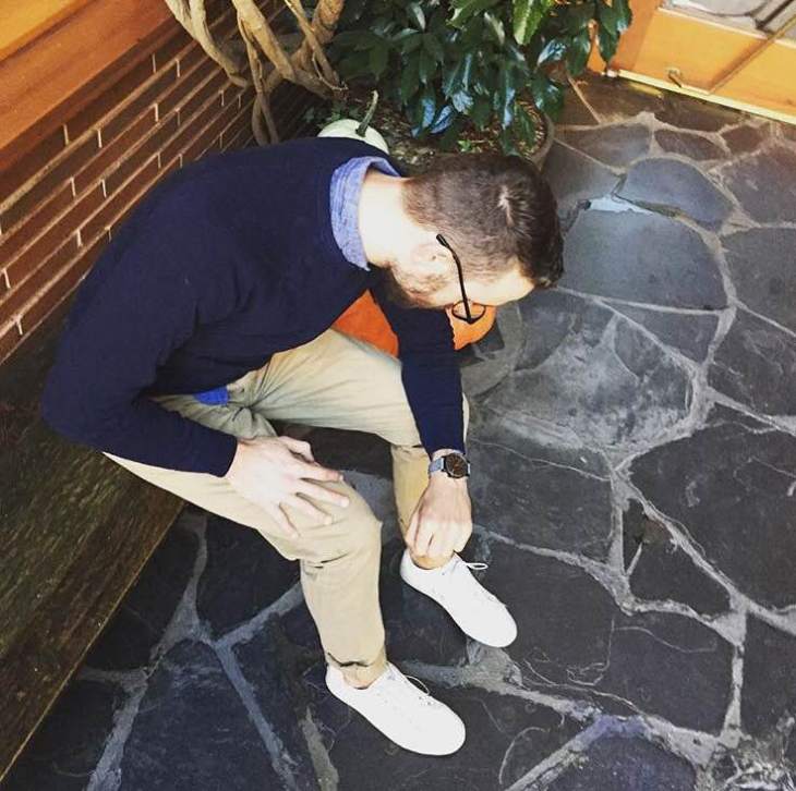 For a watch that combines high-low style with fall texture, look no further than KOMONO. Slim chinos by Taylor Stitch. Crewneck sweater by J. Crew. Chambray shirt by GAP. Glasses by Warby Parker. White sneakers by GREATS Brand.