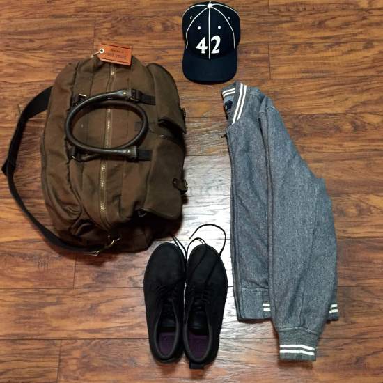 One way to style these sneakers -- with a solid baseball jacket (via Grayers), a vintage ballcap (via Goorin Brothers) and a dependable weekender bag (by Navali).