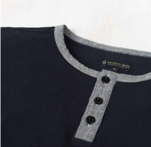 A chambray trim, three-button placket and ribbed waffle knit all provide points of visual interest.