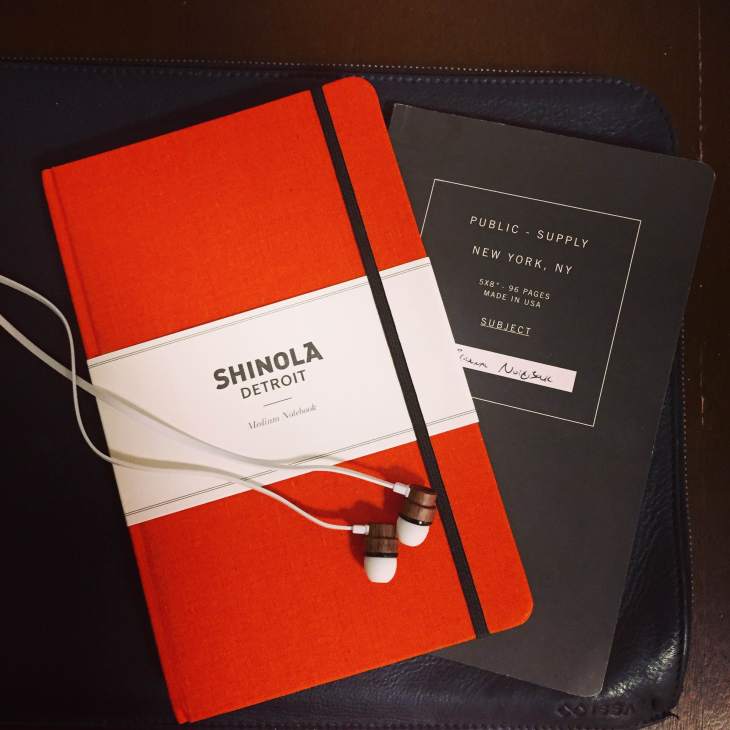 Just enough room in this Issara leather laptop sleeve to carry some nice essentials. Orange notebook by Shinola. Grey notebook by Public Supply. Wooden earphones by Woodbuds.