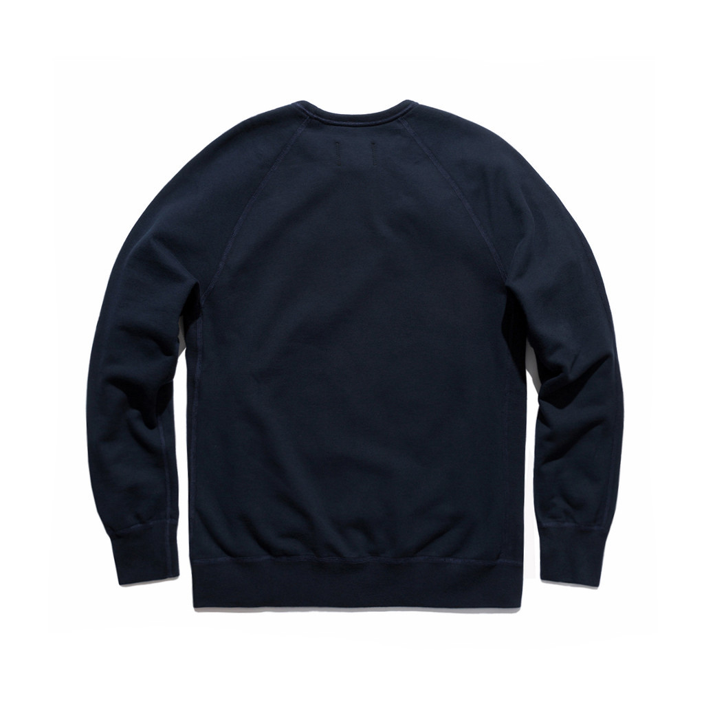 A view from the back of the Reigning Champ crewneck sweatshirt, featuring raglan should stitching.