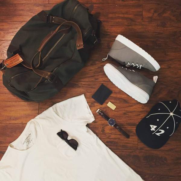 A trusty United By Blue duffle made it easy to pack up my everyday carry. Natural pocket tee by Richer Poorer. Sunglasses by Tom Ford. Brown leather watch by MVMT Watches. Vintage ballcap by Goorin Brothers. Grey-and-white chukka sneakers by Dr. Martens. Brass money clip by Owen & Fred. Navy leather card case by Issara.