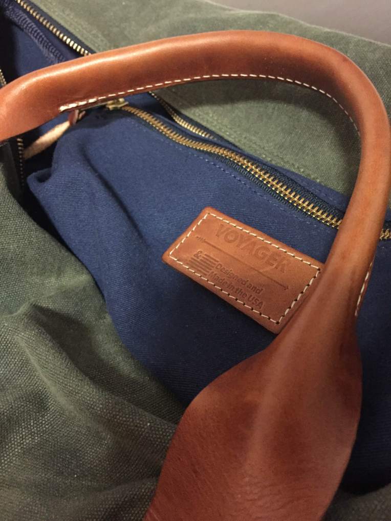 A navy twill interior and army green waxed canvas are complemented by leather handles from Wickett & Craig. 