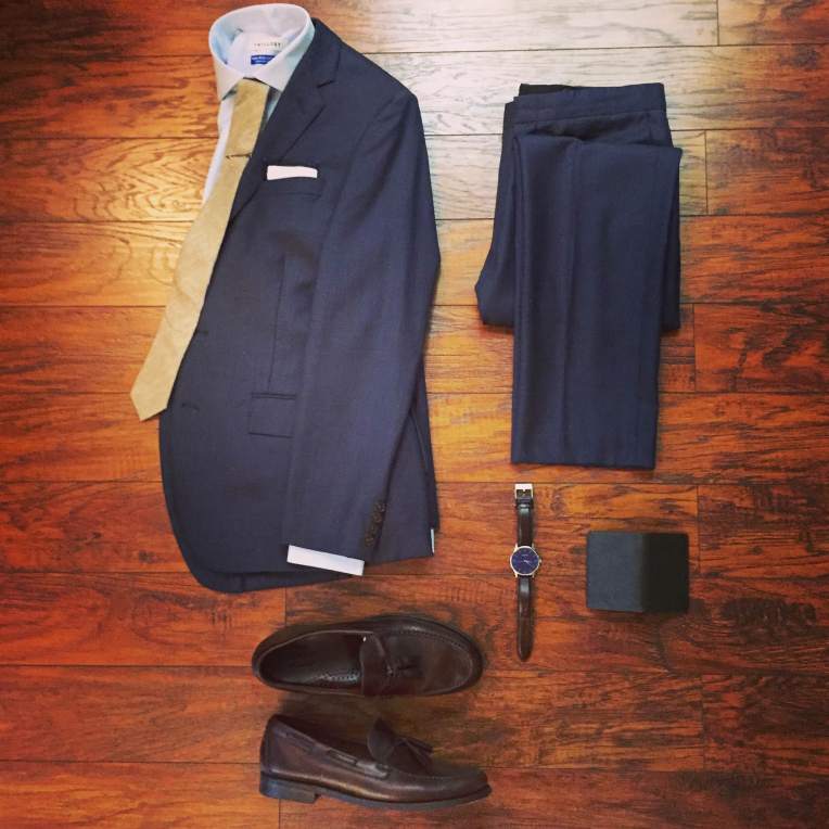 This past weekend's wedding outfit laid out and ready to go. Navy Thompson suit by J. Crew Factory. Blue shirt by Twillory. Cotton tie and tipped pocket square by Ties.com. Brown leather watch by MVMT Watches. Heritage Tassel Loafers by Sebago. Wallet from the latest SprezzaBox.