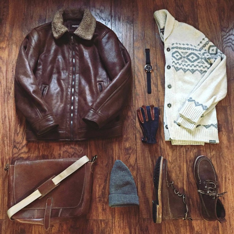 Tough essentials to fight the cold. Faux Shearling Aviator Jacket by Johnston & Murphy. Snowbridge Cardigan by Eddie Bauer. Buxton Boots by G.H. Bass. Calypso Watch by MVMT Watches. Ranger Gloves by Grifter Company. Cap by Everlane. Messenger by Brothers Leather Supply. 